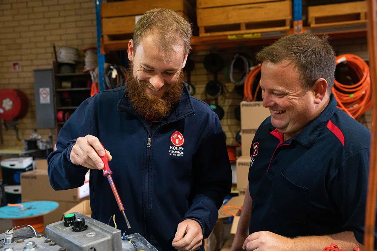 Electricians working on industrial electrical system