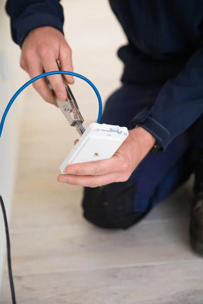 Gorey electrical employee diligently wiring some cables to a point
